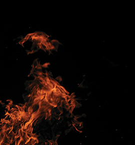 Intense orange flames against a dark background, capturing the dynamic movement and energy of fire.