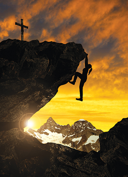 Climber scaling rocky cliff at sunset, cross atop peak, snow-capped mountains in the background.