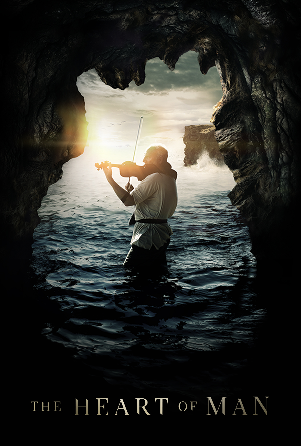 Violinist playing in a scenic cave by the sea at sunset, promotional image for The Heart of Man film.