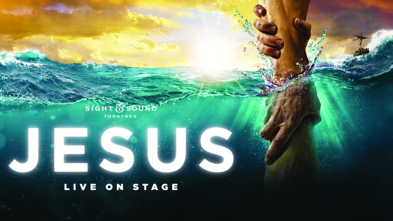 Poster of Sight & Sound Theatres' live show 'Jesus' with hands reaching through vibrant ocean waves.