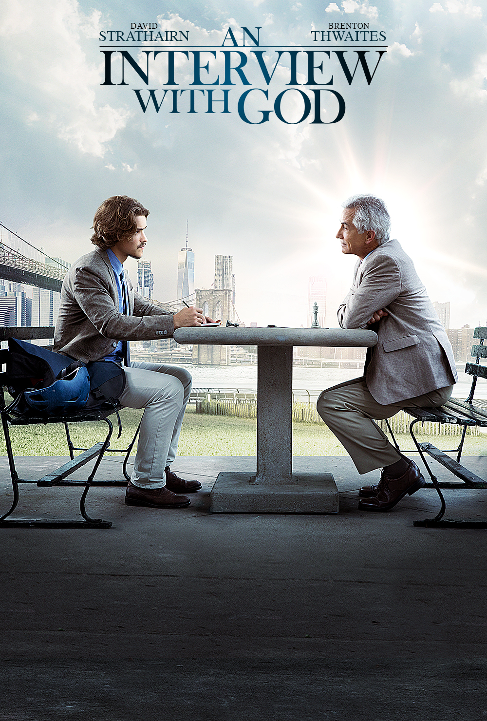 Two men conversing at a park table with a cityscape background, sunlight shining through clouds.
