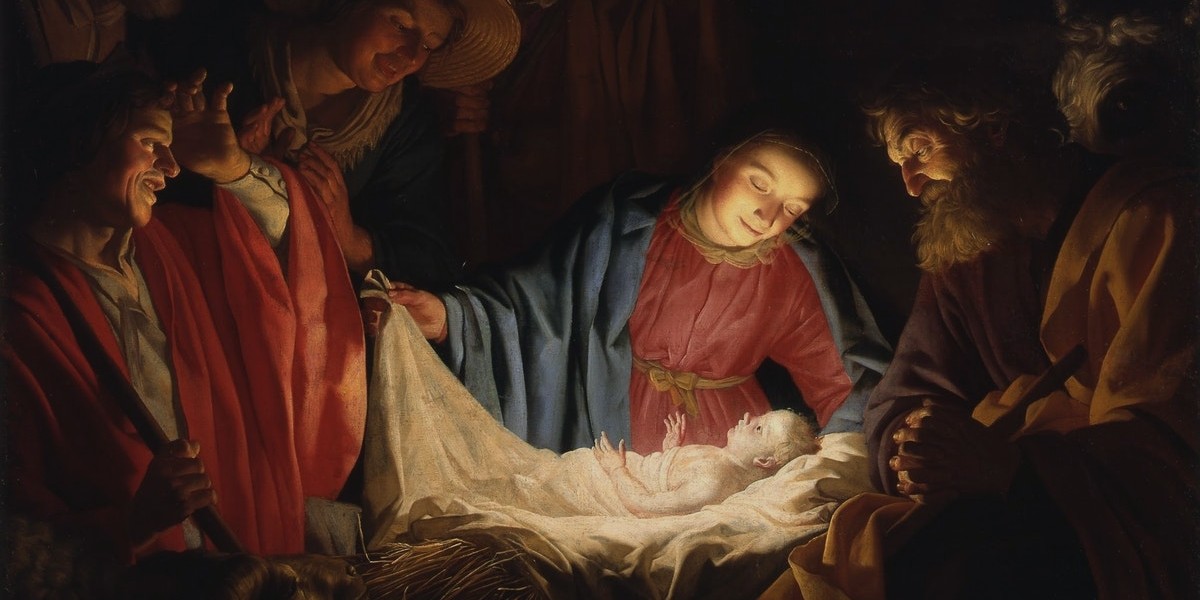 Nativity scene with the holy family and shepherds around baby Jesus in a manger.