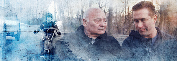 A child riding a bike; two men walking in a park, surrounded by trees on a misty day.