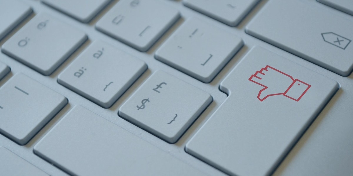 Close-up of keyboard with a thumbs down icon key on the right side.