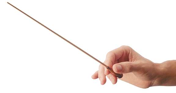 Hand holding a conductor's baton, isolated on a white background.