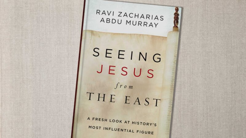 Book cover of Seeing Jesus from the East by Zacharias and Murray, resting on a textured surface.