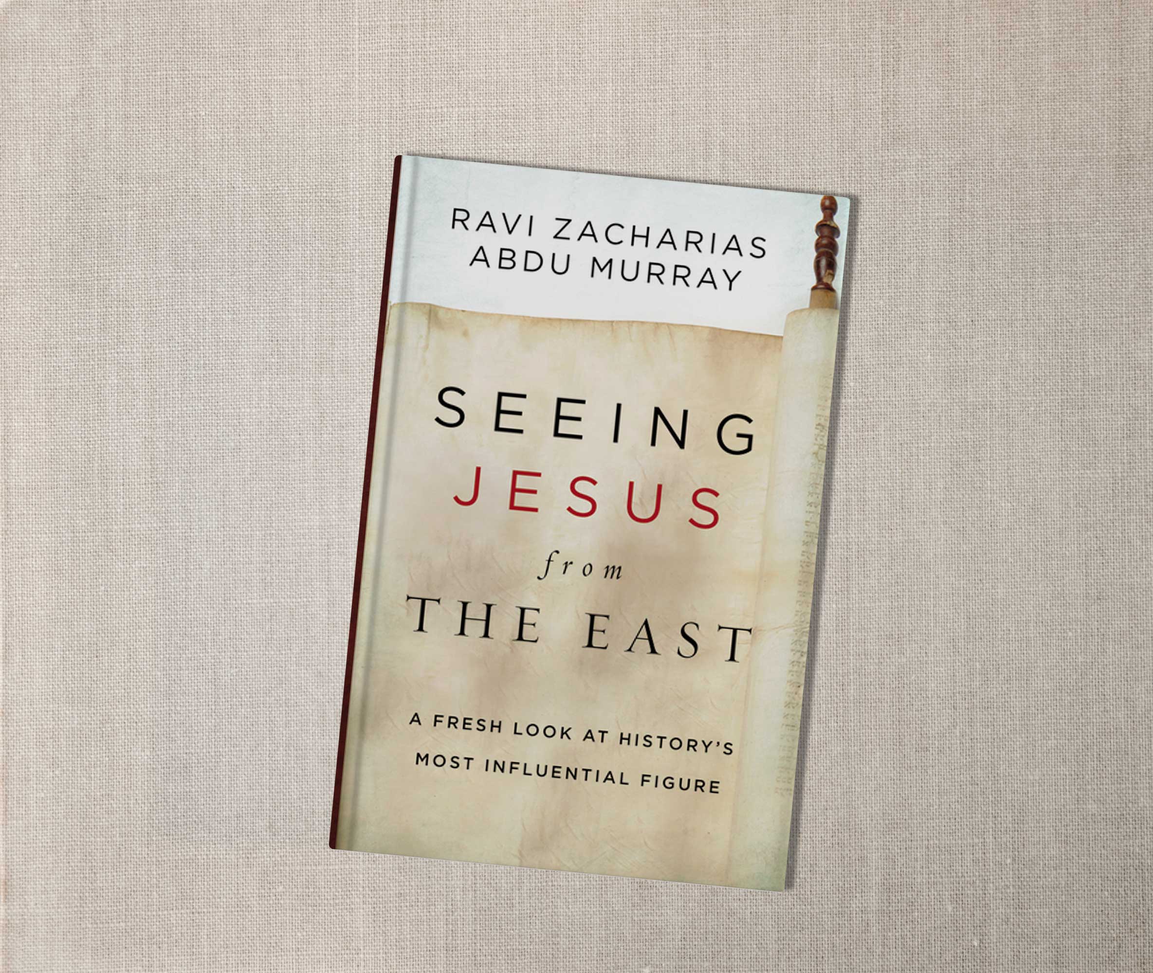 Book cover of Seeing Jesus from the East by Zacharias and Murray, resting on a textured surface.