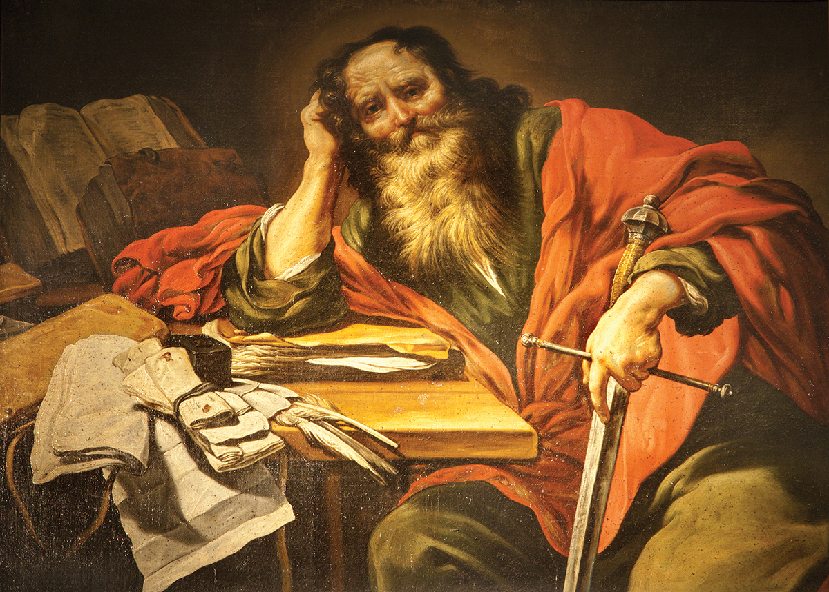 Bearded man in red robe leans on table with a sword and papers, evoking deep thought and contemplation in historical setting.