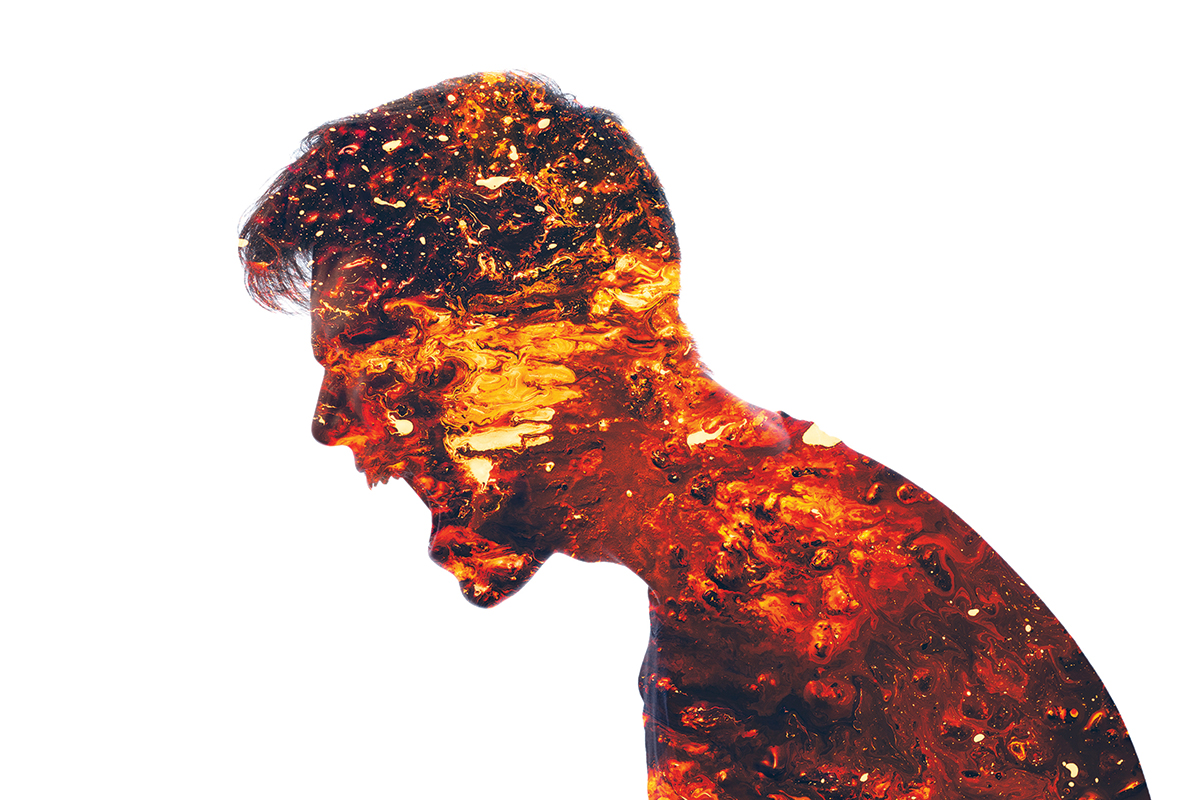 Silhouette of a person filled with fiery textures, symbolizing intense emotion and inner energy.