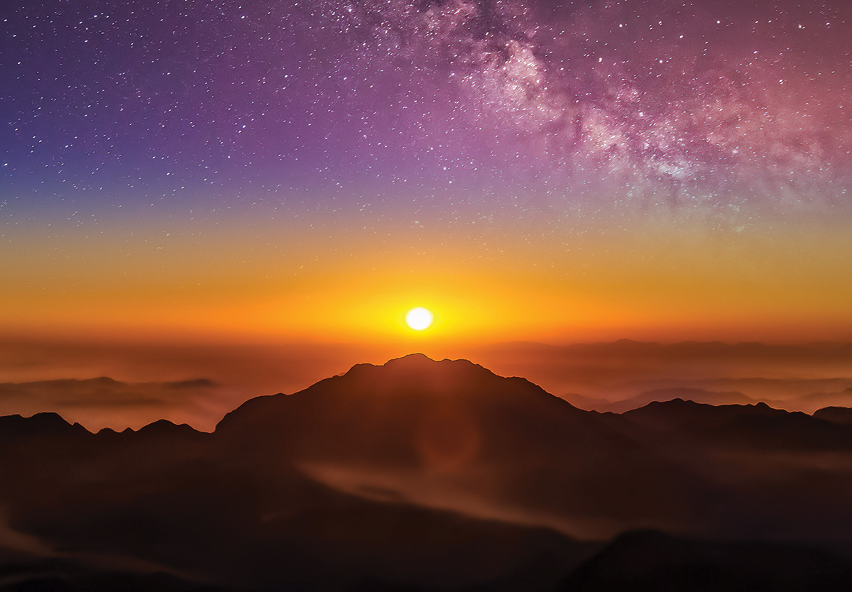 Breathtaking sunrise over misty mountains with vibrant sky and stars. Perfect for nature and travel enthusiasts.