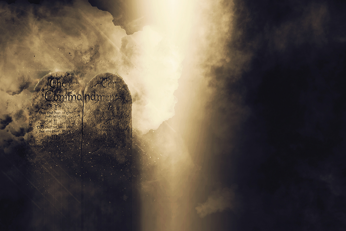 Stone tablets with Ten Commandments surrounded by mist and light.