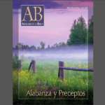 Magazine cover displaying a misty field and wildflowers, titled Alabanza y Preceptos, with a nature theme.