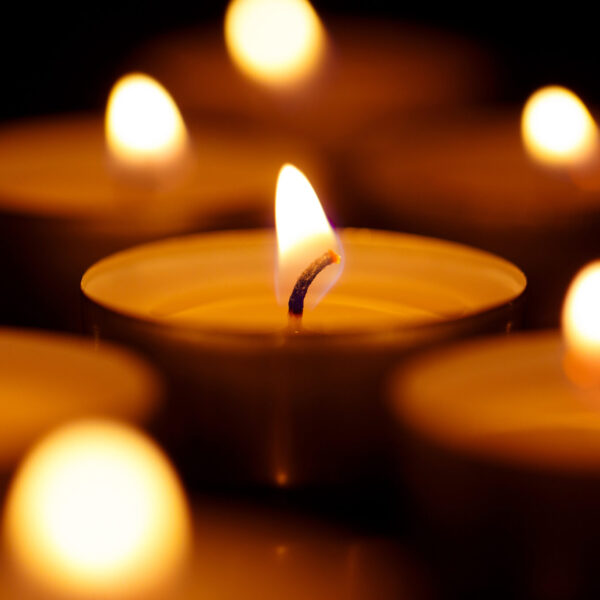 Burning candles on black