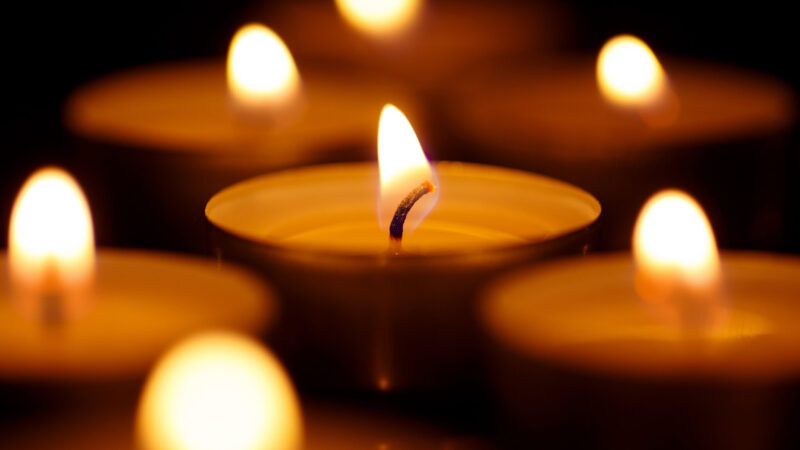 Burning candles on black